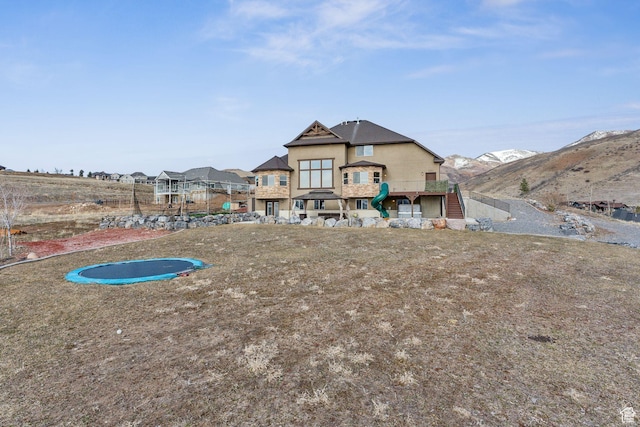 1101 E Stage Coach Run N, Morgan, UT 84050 - rear view of property featuring stucco siding, a trampoline, and stairway