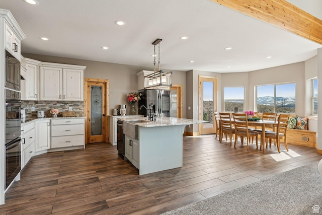 1101 E Stage Coach Run N, Morgan, UT 84050 - kitchen featuring stainless steel fridge with ice dispenser, dark wood-style floors, an island with sink, and tasteful backsplash