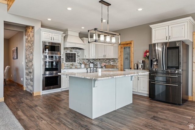 1101 E Stage Coach Run N, Morgan, UT 84050 - kitchen with dark wood finished floors, stainless steel appliances, custom range hood, and tasteful backsplash