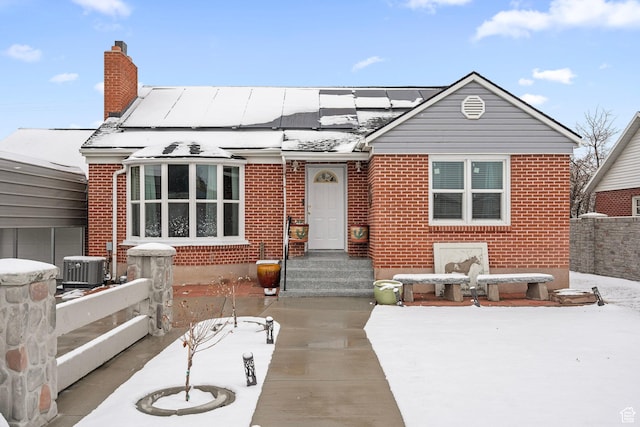 319 N 800 W, Orem, UT 84057 - view of front of property featuring brick siding, solar panels, fence, and a chimney