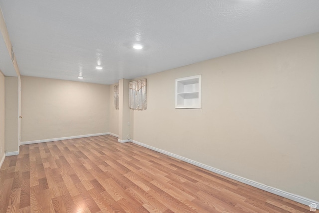 319 N 800 W, Orem, UT 84057 - finished below grade area featuring baseboards, a textured ceiling, and light wood-style floors