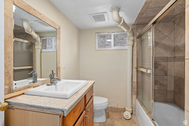 319 N 800 W, Orem, UT 84057 - full bath with vanity, stone tile floors, toilet, visible vents, and enclosed tub / shower combo
