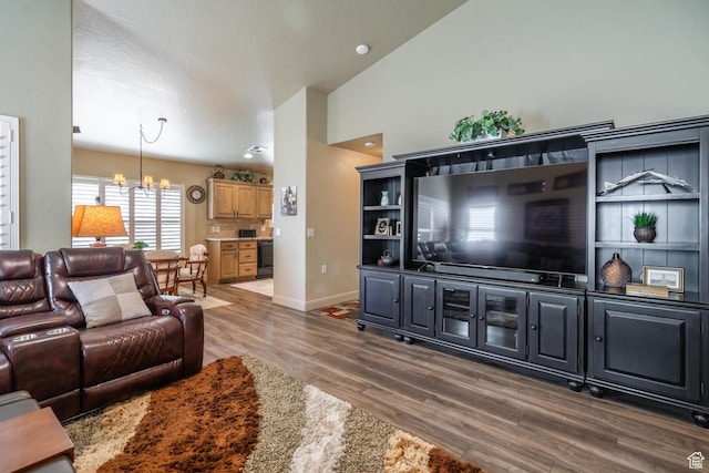 1369 W Country Club Dr, St George, UT 84790 - living room with an inviting chandelier, baseboards, vaulted ceiling, and wood finished floors