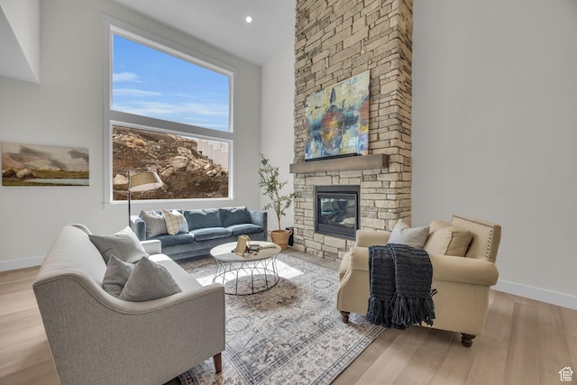 6579 W Bonnie Jean Ln Unit 12, Herriman, UT 84096 - living room with recessed lighting, baseboards, a high ceiling, a fireplace, and wood finished floors