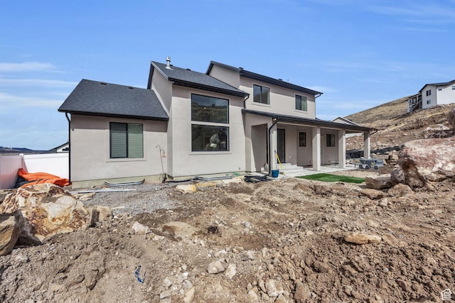 6579 W Bonnie Jean Ln Unit 12, Herriman, UT 84096 - rear view of house with a shingled roof, stucco siding, and fence