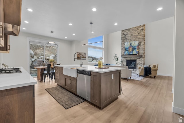 6579 W Bonnie Jean Ln Unit 12, Herriman, UT 84096 - kitchen featuring light countertops, a sink, stainless steel appliances, and light wood-type flooring