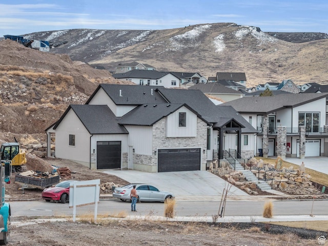 6579 W Bonnie Jean Ln Unit 12, Herriman, UT 84096 - view of front of property featuring stone siding, concrete driveway, roof with shingles, a residential view, and a mountain view