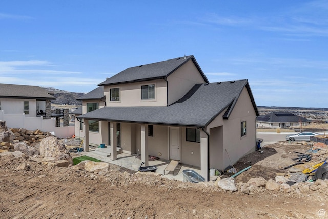 6579 W Bonnie Jean Ln Unit 12, Herriman, UT 84096 - rear view of house featuring stucco siding, a shingled roof, fence, and a patio area