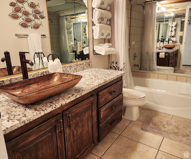 bathroom with toilet, vanity, tile patterned floors, and shower / tub combo with curtain