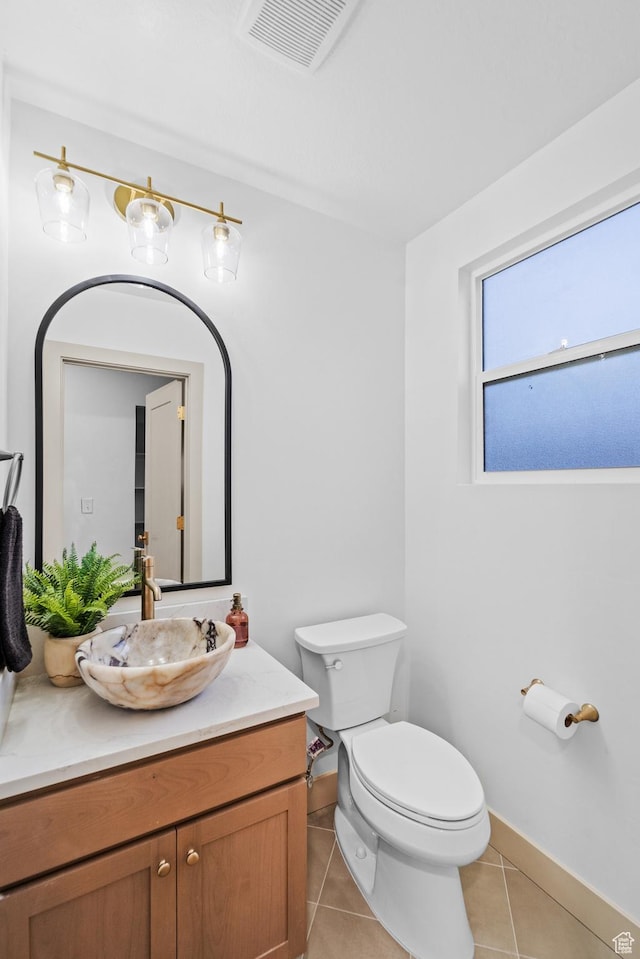 1585 S 2300 E, Salt Lake City, UT 84108 - half bath featuring toilet, vanity, visible vents, tile patterned flooring, and baseboards
