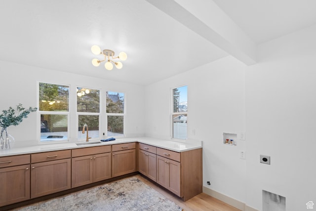 1585 S 2300 E, Salt Lake City, UT 84108 - clothes washing area with a sink, electric dryer hookup, washer hookup, a notable chandelier, and light wood-type flooring