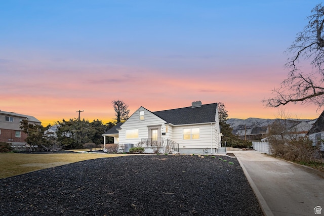 1585 S 2300 E, Salt Lake City, UT 84108 - bungalow-style house featuring fence, concrete driveway, a shingled roof, and a chimney