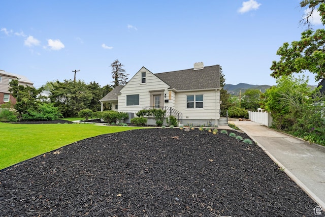 1585 S 2300 E, Salt Lake City, UT 84108 - bungalow-style home featuring a chimney, fence, concrete driveway, roof with shingles, and a front lawn