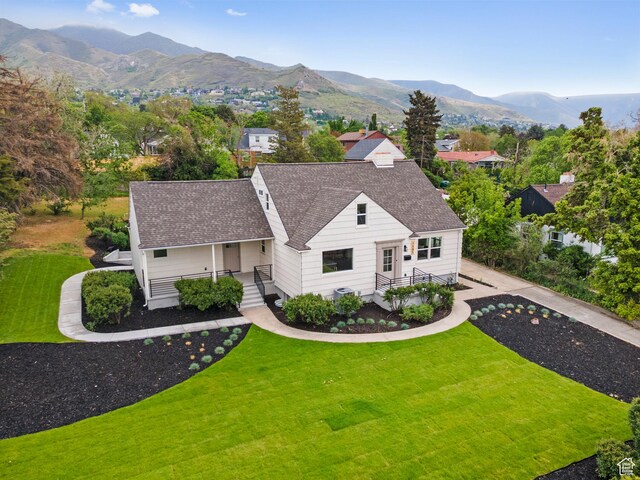 1585 S 2300 E, Salt Lake City, UT 84108 - view of front of house with a front yard, a porch, roof with shingles, and a mountain view