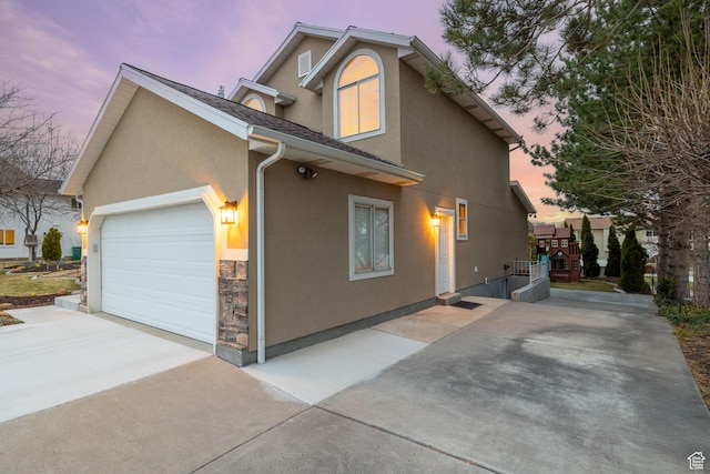 4721 W Country Club Dr, Highland, UT 84003 - view of home's exterior with driveway, stucco siding, a garage, and stone siding
