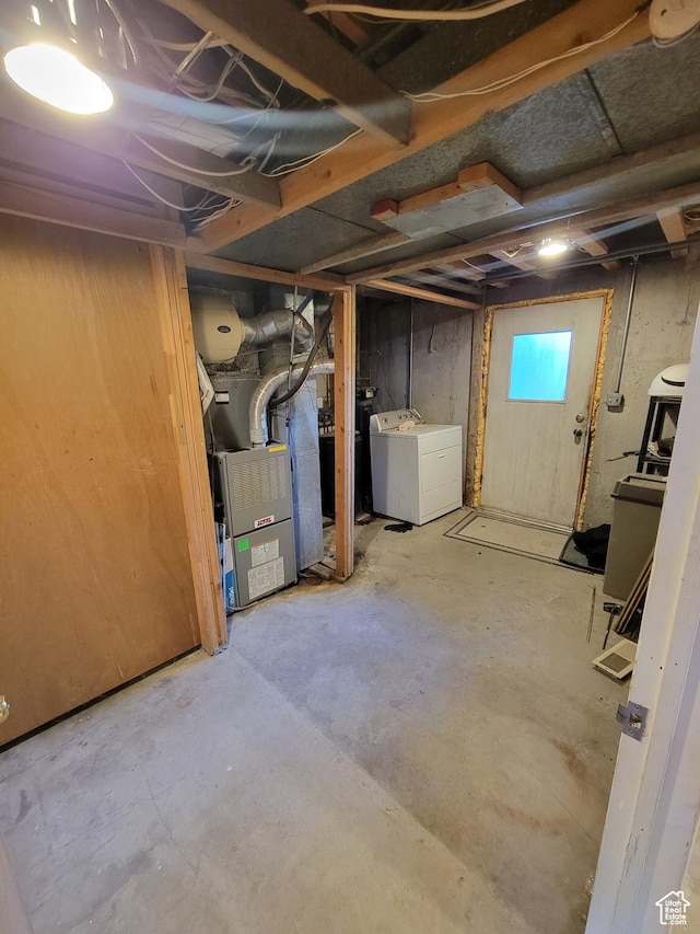 basement featuring washer and dryer and heating unit