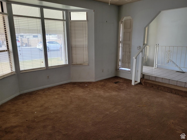 carpeted empty room with baseboards