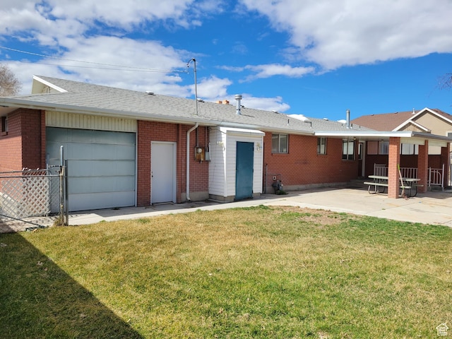back of house with a patio area, fence, brick siding, and a lawn