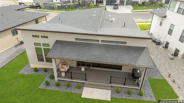 5516 N Valley View Rd, Lehi, UT 84043 - back of house with stucco siding, a lawn, roof with shingles, and a residential view