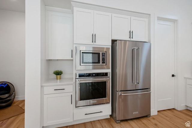 5516 N Valley View Rd, Lehi, UT 84043 - kitchen with white cabinetry, light countertops, stainless steel appliances, and light wood-style floors