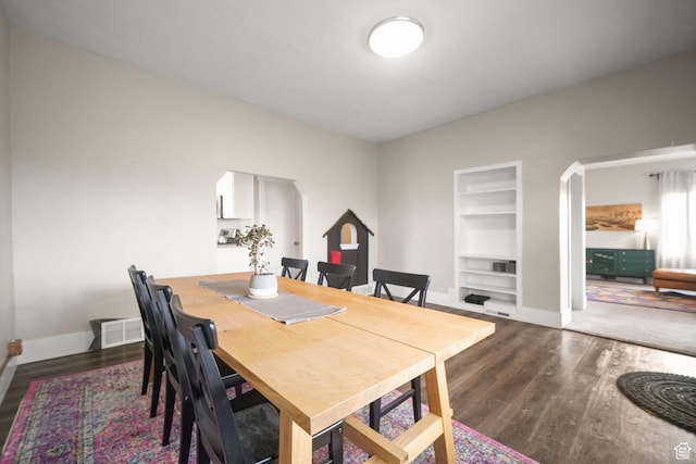 214 W 600 S, Heber City, UT 84032 - dining space featuring built in features, arched walkways, dark wood-type flooring, and baseboards