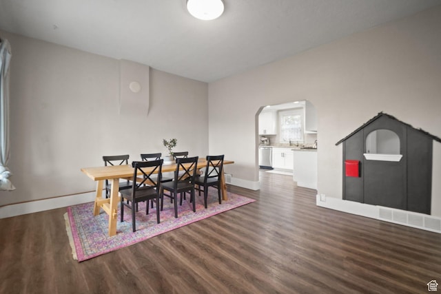 214 W 600 S, Heber City, UT 84032 - dining room featuring dark wood finished floors, baseboards, visible vents, and arched walkways