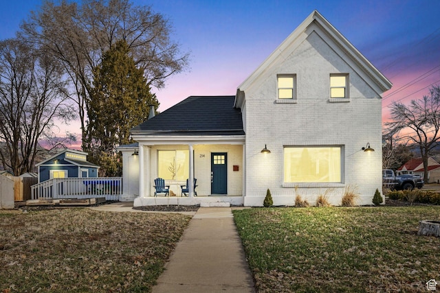 214 W 600 S, Heber City, UT 84032 - traditional-style house featuring a lawn, brick siding, and a porch