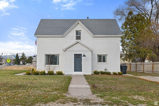 214 W 600 S, Heber City, UT 84032 - view of front of house with brick siding, fence, and a front lawn
