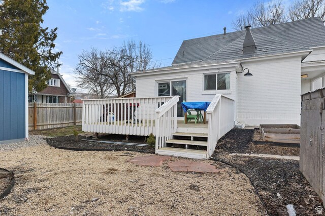 214 W 600 S, Heber City, UT 84032 - back of property featuring a shingled roof, a wooden deck, fence, and brick siding