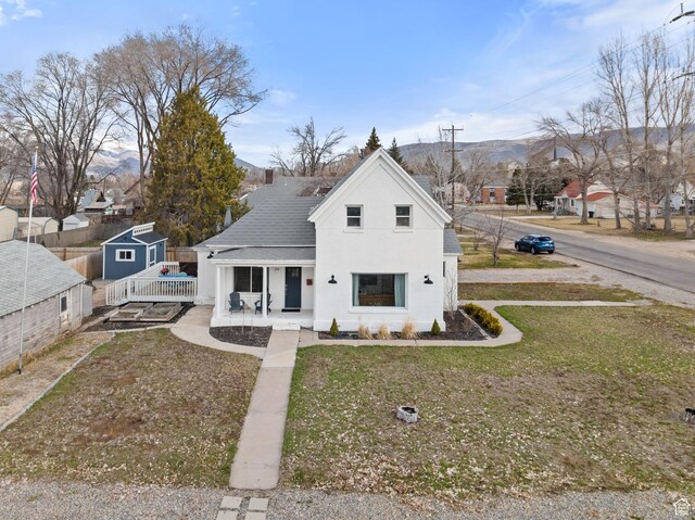 214 W 600 S, Heber City, UT 84032 - bungalow-style home featuring fence, an outbuilding, a front lawn, stucco siding, and covered porch
