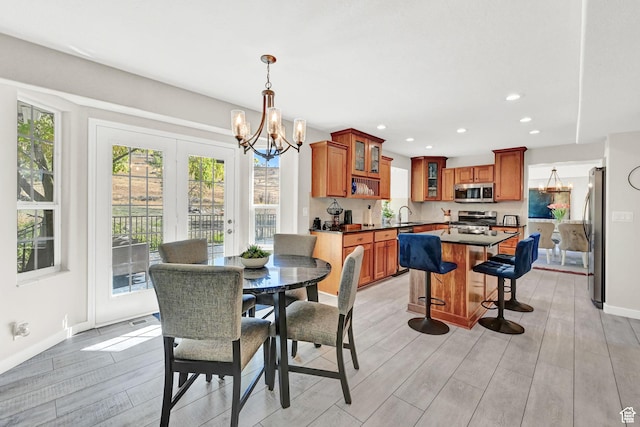 4216 N Wolf Creek Dr, Eden, UT 84310 - dining room featuring baseboards, light wood-style flooring, recessed lighting, and a chandelier
