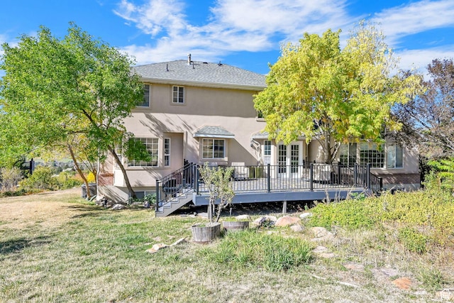 4216 N Wolf Creek Dr, Eden, UT 84310 - back of property featuring stucco siding, a lawn, and a deck