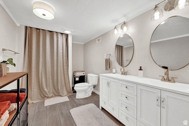 4216 N Wolf Creek Dr, Eden, UT 84310 - full bath featuring toilet, a sink, ornamental molding, and wood finished floors