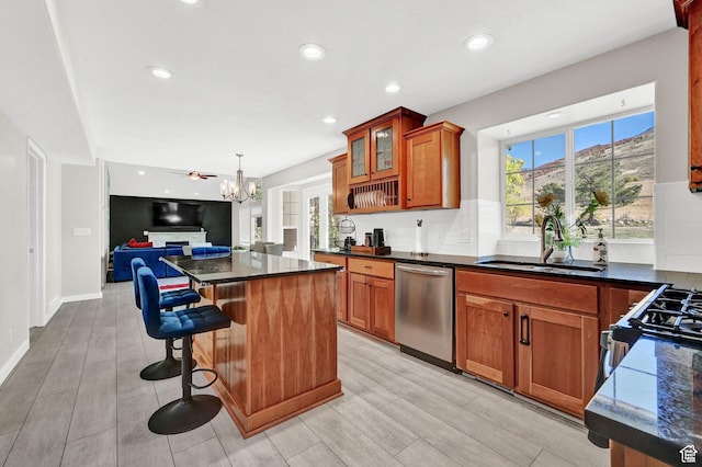 4216 N Wolf Creek Dr, Eden, UT 84310 - kitchen with a chandelier, stainless steel dishwasher, a kitchen island, a sink, and brown cabinets
