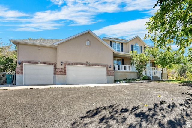 4216 N Wolf Creek Dr, Eden, UT 84310 - view of front of house featuring stucco siding, brick siding, and an attached garage