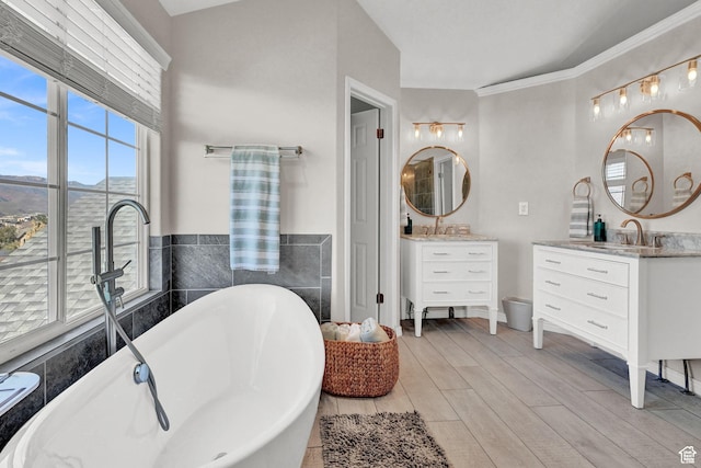 4216 N Wolf Creek Dr, Eden, UT 84310 - bathroom with a soaking tub, a sink, two vanities, and wood finished floors