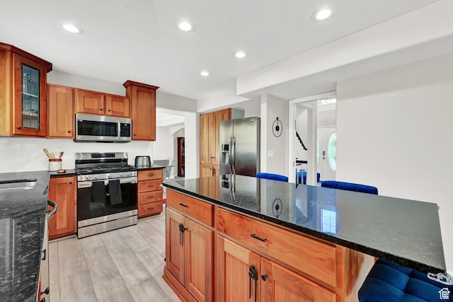 4216 N Wolf Creek Dr, Eden, UT 84310 - kitchen featuring light wood-type flooring, recessed lighting, dark stone countertops, and stainless steel appliances