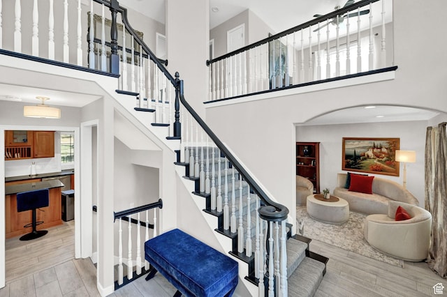 4216 N Wolf Creek Dr, Eden, UT 84310 - stairway with a high ceiling, arched walkways, and wood finished floors