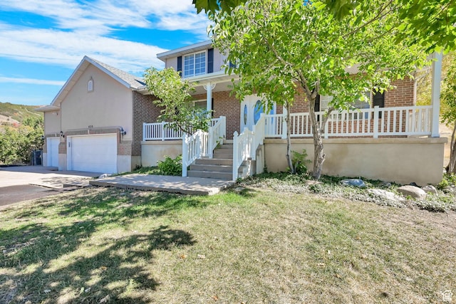 4216 N Wolf Creek Dr, Eden, UT 84310 - view of property hidden behind natural elements featuring driveway, a front yard, an attached garage, brick siding, and a porch