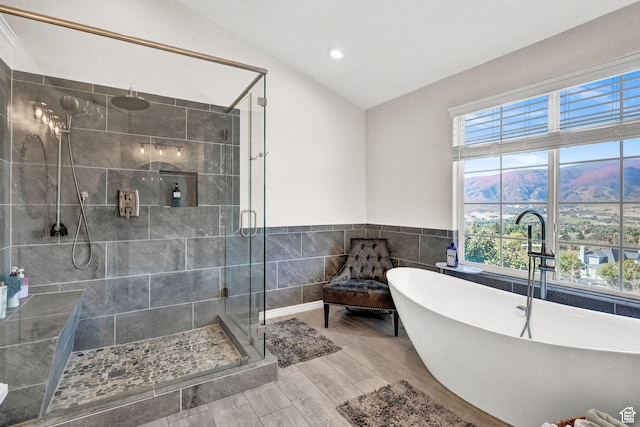 4216 N Wolf Creek Dr, Eden, UT 84310 - full bath with a stall shower, a freestanding tub, wood finished floors, lofted ceiling, and tile walls