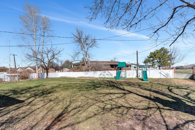 view of yard featuring playground community and fence private yard