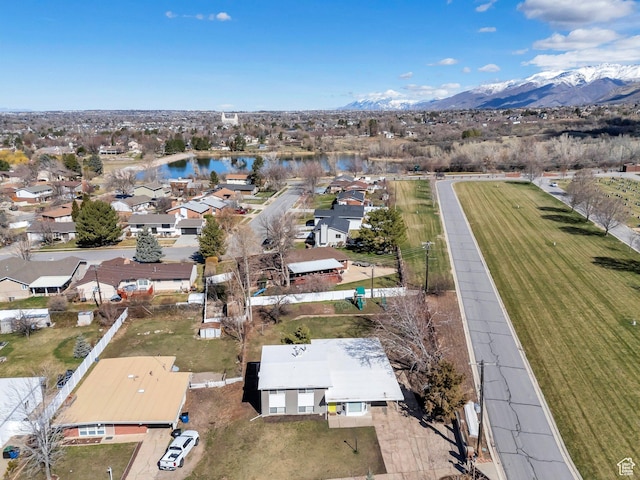 birds eye view of property featuring a water and mountain view and a residential view