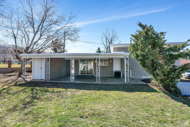 rear view of house featuring a patio area, central air condition unit, fence, and a lawn