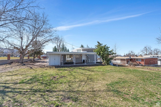 rear view of property featuring a patio area, fence, and a lawn