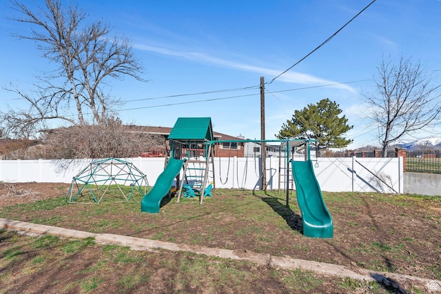 community playground featuring a fenced backyard