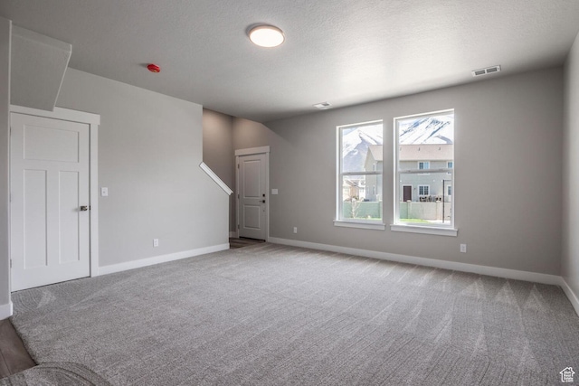 2746 E 1060 S, Spanish Fork, UT 84660 - unfurnished living room with carpet flooring, baseboards, and a textured ceiling