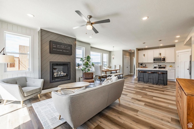 2748 E 1060 S, Spanish Fork, UT 84660 - living room with a fireplace, a textured ceiling, light wood-style floors, ceiling fan, and recessed lighting