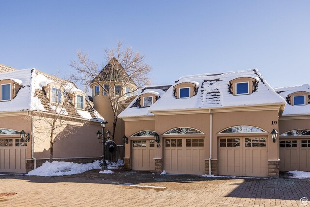 2726 E Wasatch Dr Unit 18, Salt Lake City, UT 84108 - view of front of house featuring a garage, decorative driveway, and stucco siding