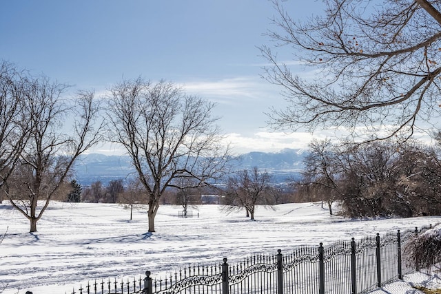 2726 E Wasatch Dr Unit 18, Salt Lake City, UT 84108 - yard covered in snow with a mountain view and fence