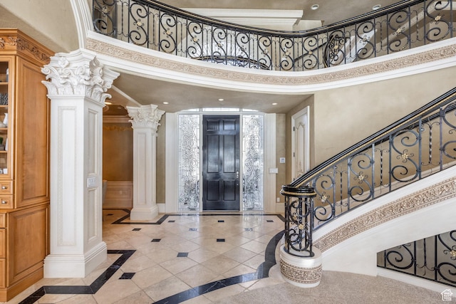 2726 E Wasatch Dr Unit 18, Salt Lake City, UT 84108 - foyer entrance featuring decorative columns, baseboards, a high ceiling, and stairway